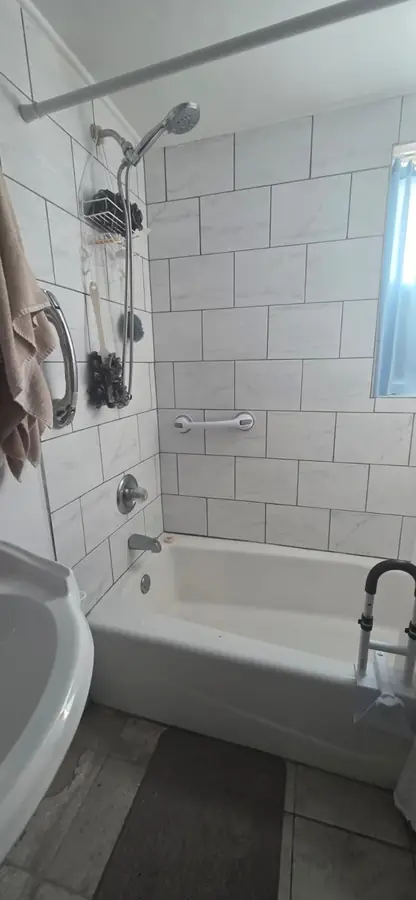 The same bathroom before, with an old bathtub